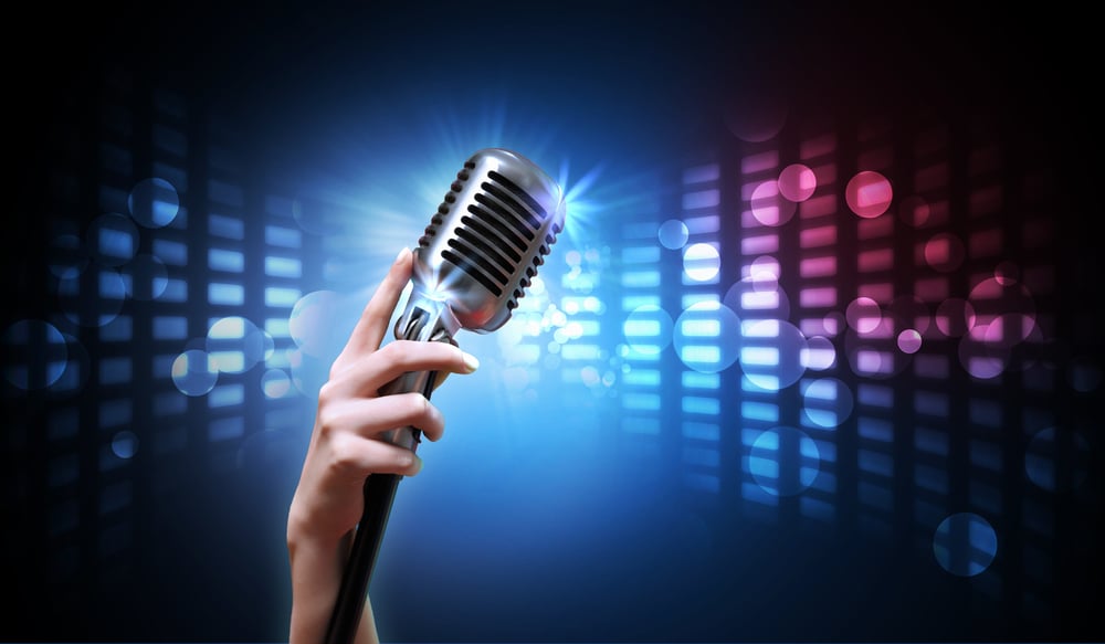 Single retro microphone against colourful background with lights Single retro microphone against colourful background with lights